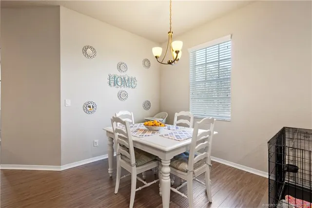 a view of a dining room with furniture wooden floor and a chandelier