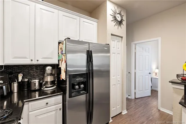 a kitchen with stainless steel appliances granite countertop a refrigerator and a stove
