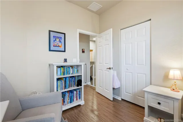 a living room with furniture and a book shelf