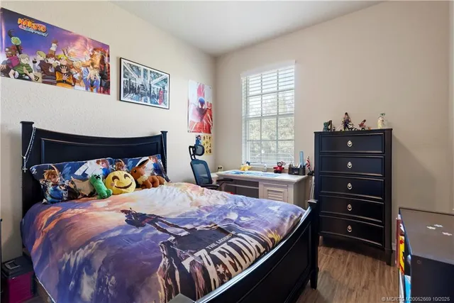 a bedroom with a bed and a dresser in it