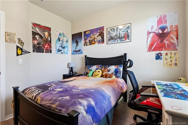 a bedroom with bed and wall painting on the wall