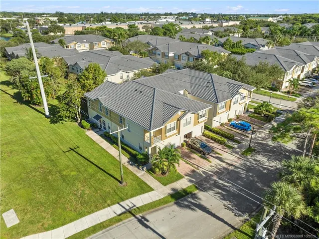 an aerial view of a house with a yard