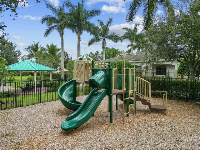 a childrens park with lots of swings and slides