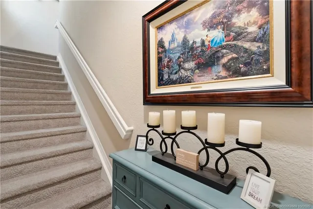 a view of a entryway with wooden floor and a painting on the wall