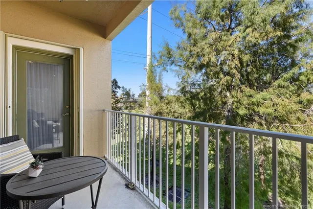 a view of a balcony with chair and wooden floor