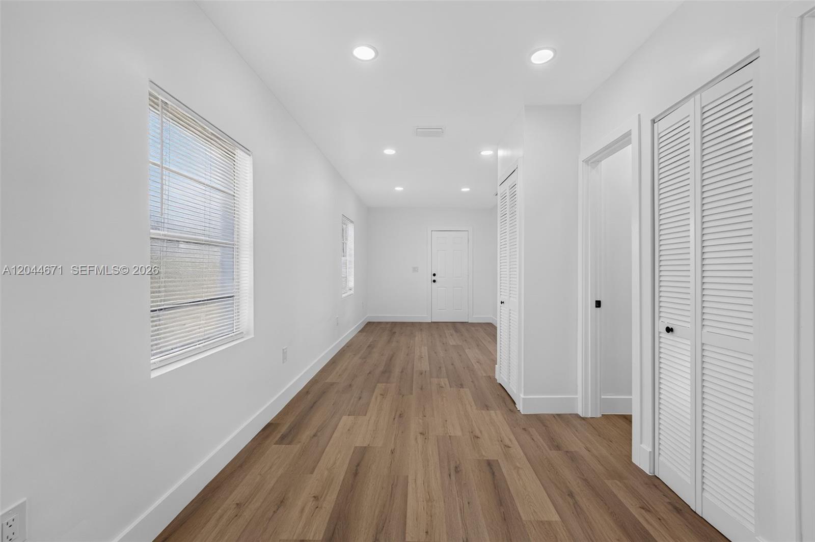 1900 Southwest 6th Street, Unit 6 Miami, FL 33135 - Photo 13 of 20 a view of a room with wooden floors and natural light