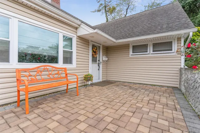 a backyard of a house with barbeque oven table and chairs