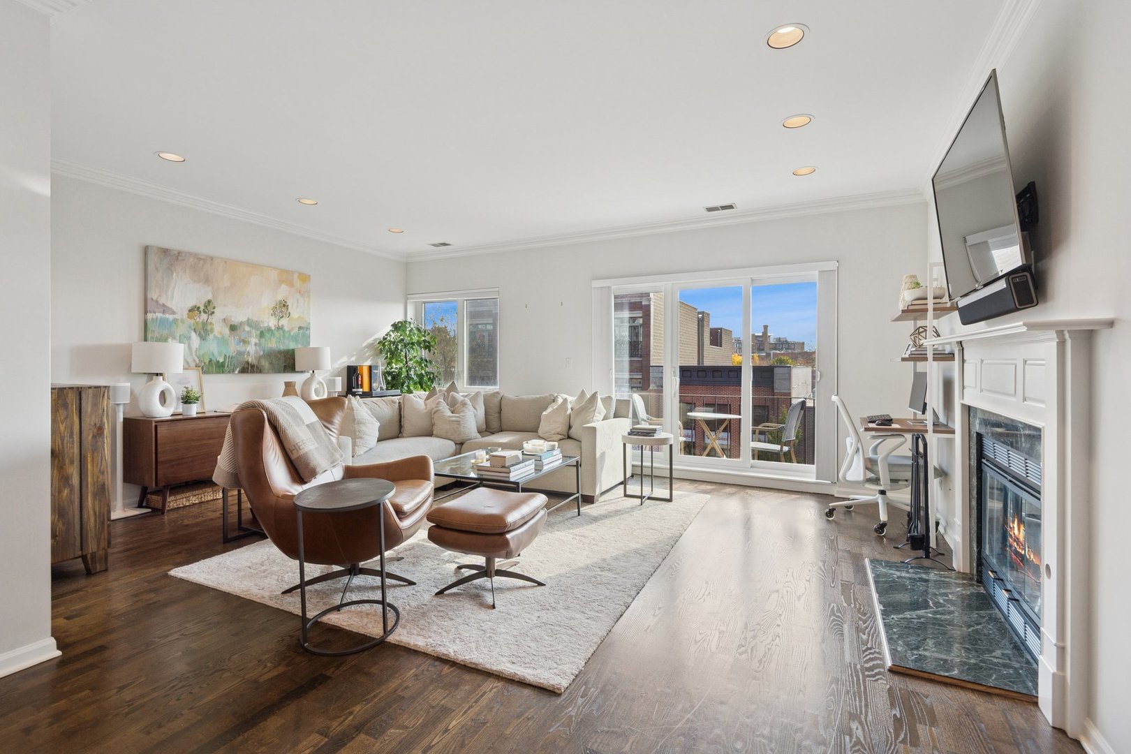 1122 West Armitage Avenue, Unit 302 Chicago, IL 60614 - Photo 3 of 23 a living room with furniture a flat screen tv and a fireplace