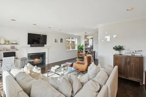 a living room with furniture a fireplace and a flat screen tv
