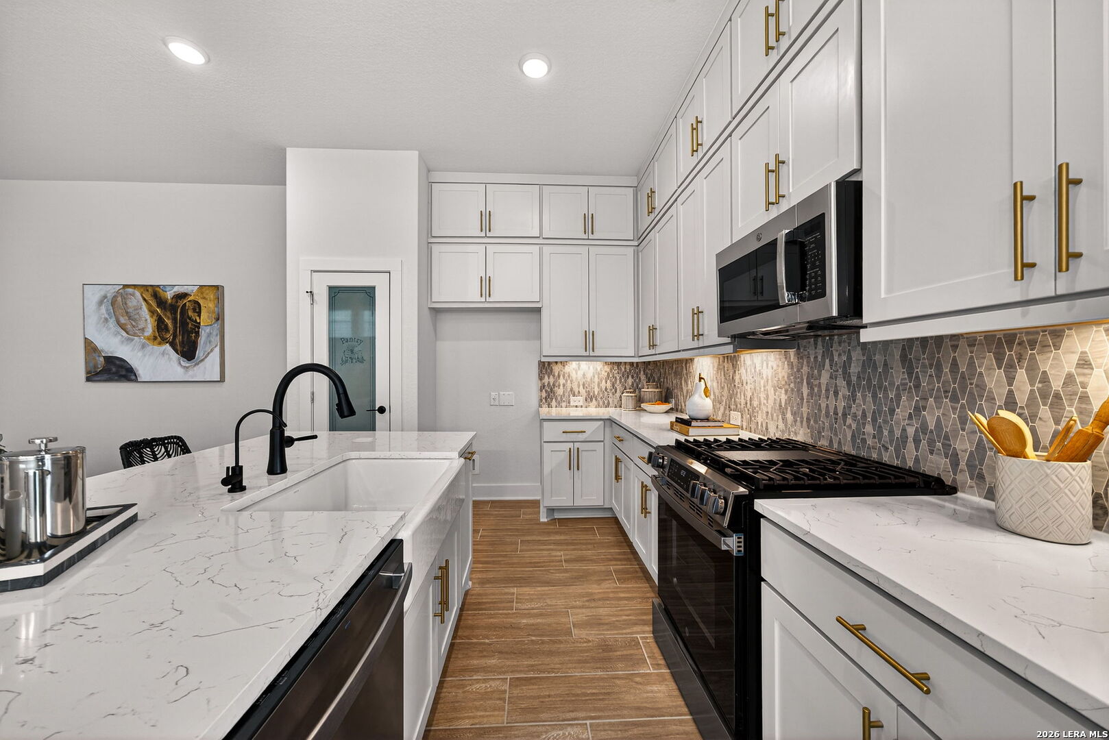 20675 Huebner Road, Unit 527 San Antonio, TX 78258 - Photo 12 of 33 a kitchen with stainless steel appliances granite countertop a sink a stove top oven a counter space and cabinets