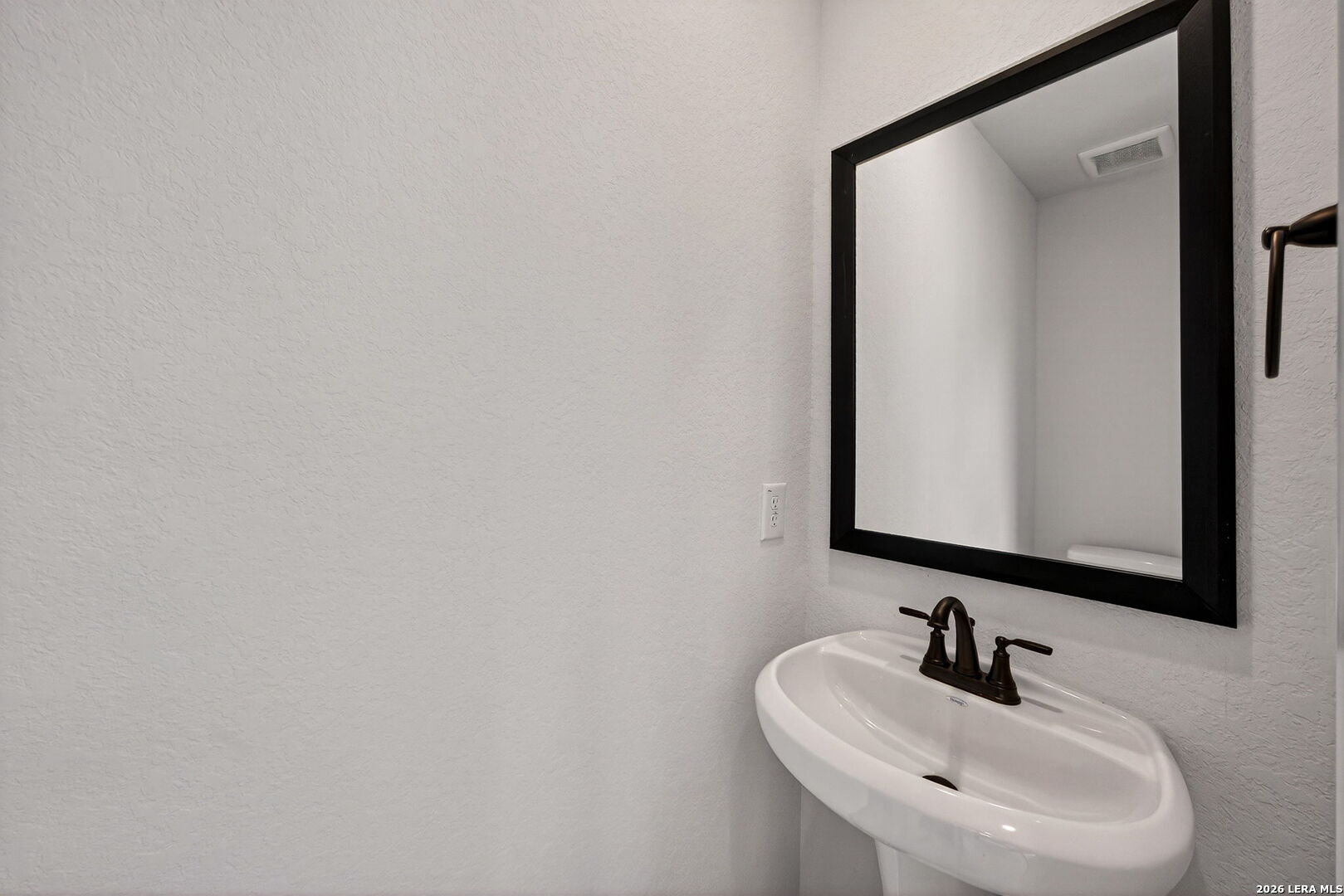 20675 Huebner Road, Unit 527 San Antonio, TX 78258 - Photo 17 of 33 a bathroom with a sink and a mirror