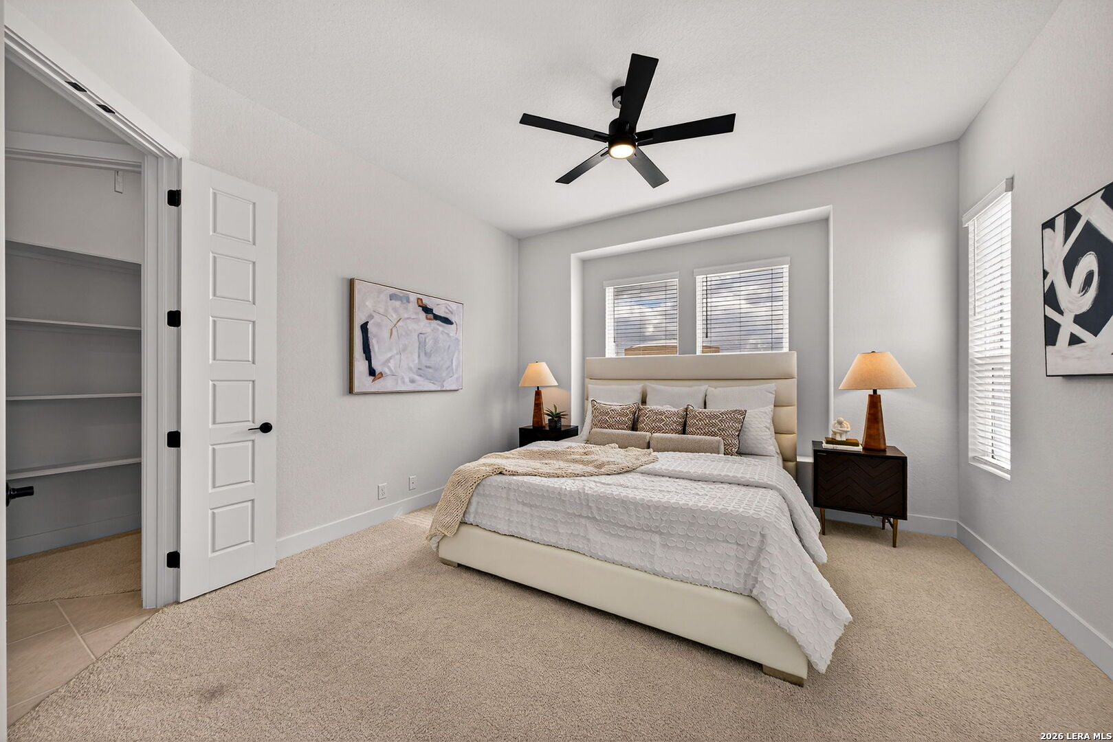 20675 Huebner Road, Unit 527 San Antonio, TX 78258 - Photo 18 of 33 a bedroom with a bed and a chandelier