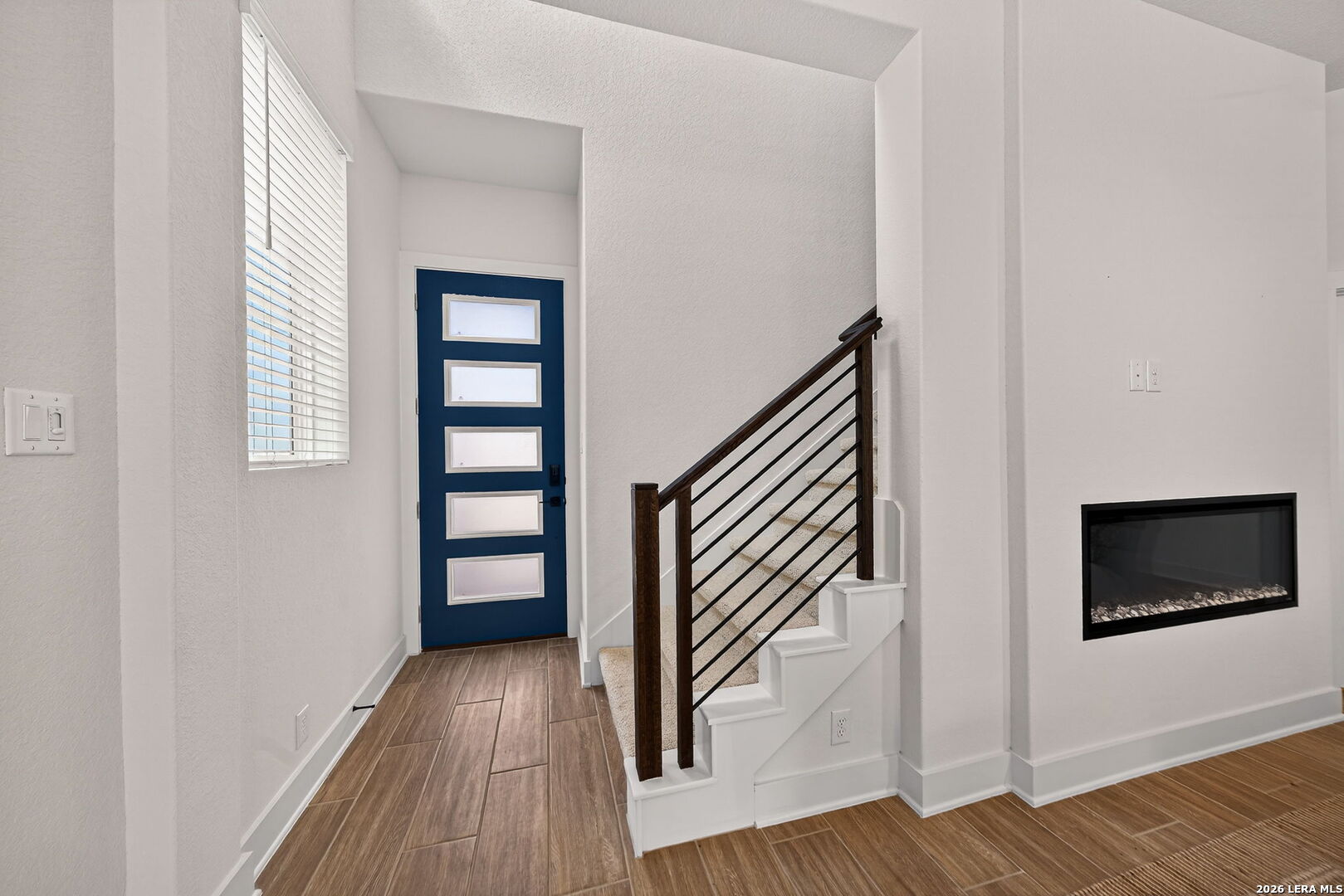 20675 Huebner Road, Unit 527 San Antonio, TX 78258 - Photo 5 of 33 an entryway and livingroom with wooden floor