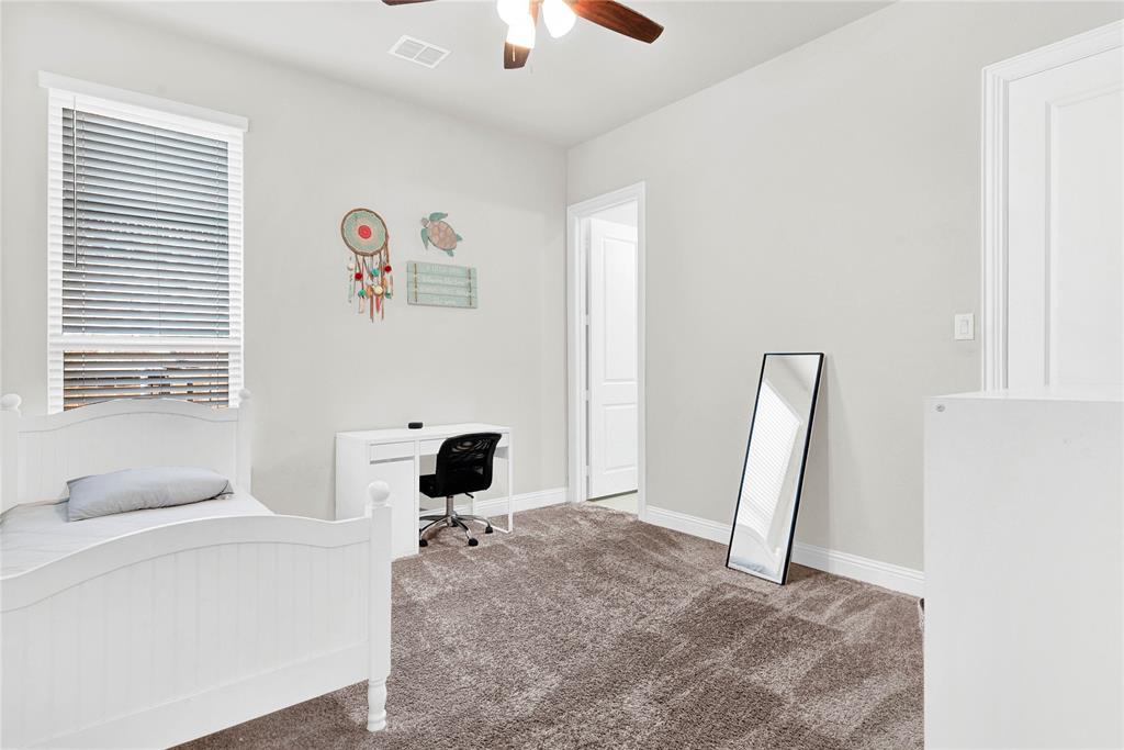 616 Windy Ridge Lane Rockwall, TX 75087 - Photo 12 of 25 a living room with a baby crib furniture and a window