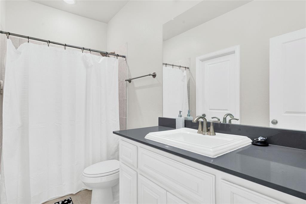 616 Windy Ridge Lane Rockwall, TX 75087 - Photo 17 of 25 a bathroom with a sink and a mirror