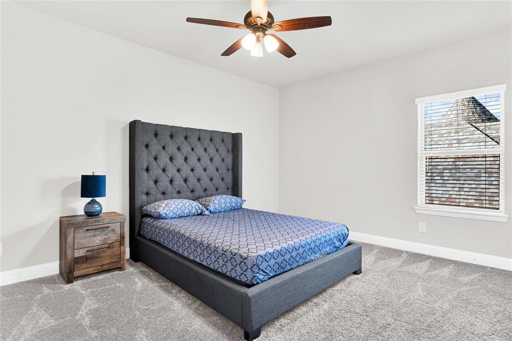 616 Windy Ridge Lane Rockwall, TX 75087 - Photo 18 of 25 a bedroom with a bed and window