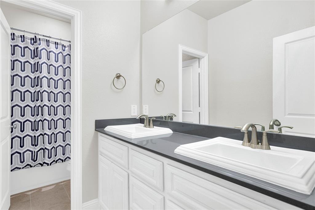 616 Windy Ridge Lane Rockwall, TX 75087 - Photo 19 of 25 a bathroom with a sink and a mirror