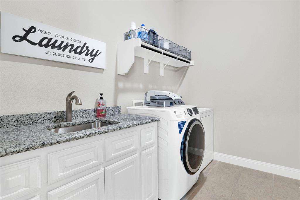 616 Windy Ridge Lane Rockwall, TX 75087 - Photo 21 of 25 a utility room with sink dryer and washer