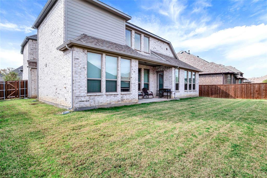 616 Windy Ridge Lane Rockwall, TX 75087 - Photo 22 of 25 a view of a house with a yard and sitting area