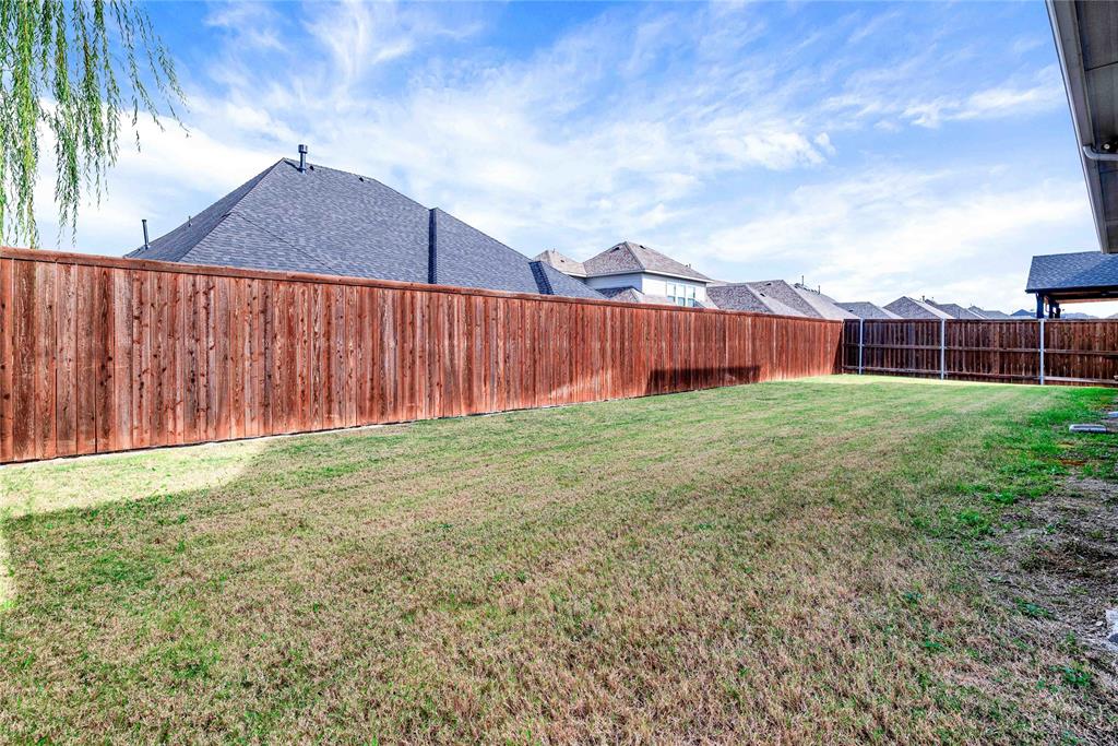 616 Windy Ridge Lane Rockwall, TX 75087 - Photo 24 of 25 a view of backyard with a cabin and wooden fence