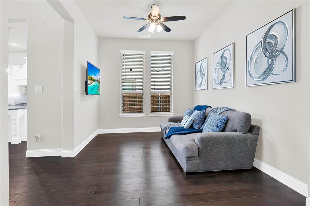616 Windy Ridge Lane Rockwall, TX 75087 - Photo 4 of 25 a living room with couches and a window with wooden floor