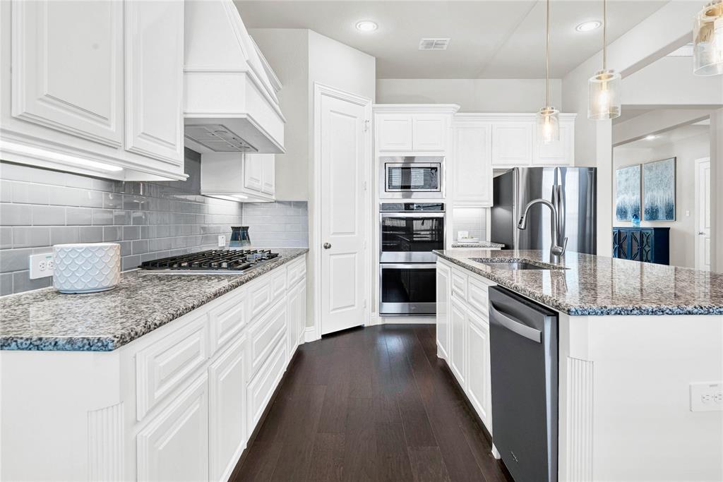 616 Windy Ridge Lane Rockwall, TX 75087 - Photo 6 of 25 a large kitchen with granite countertop a lot of counter space