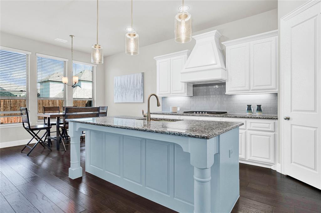 616 Windy Ridge Lane Rockwall, TX 75087 - Photo 7 of 25 a kitchen with granite countertop a sink a counter space appliances and cabinets