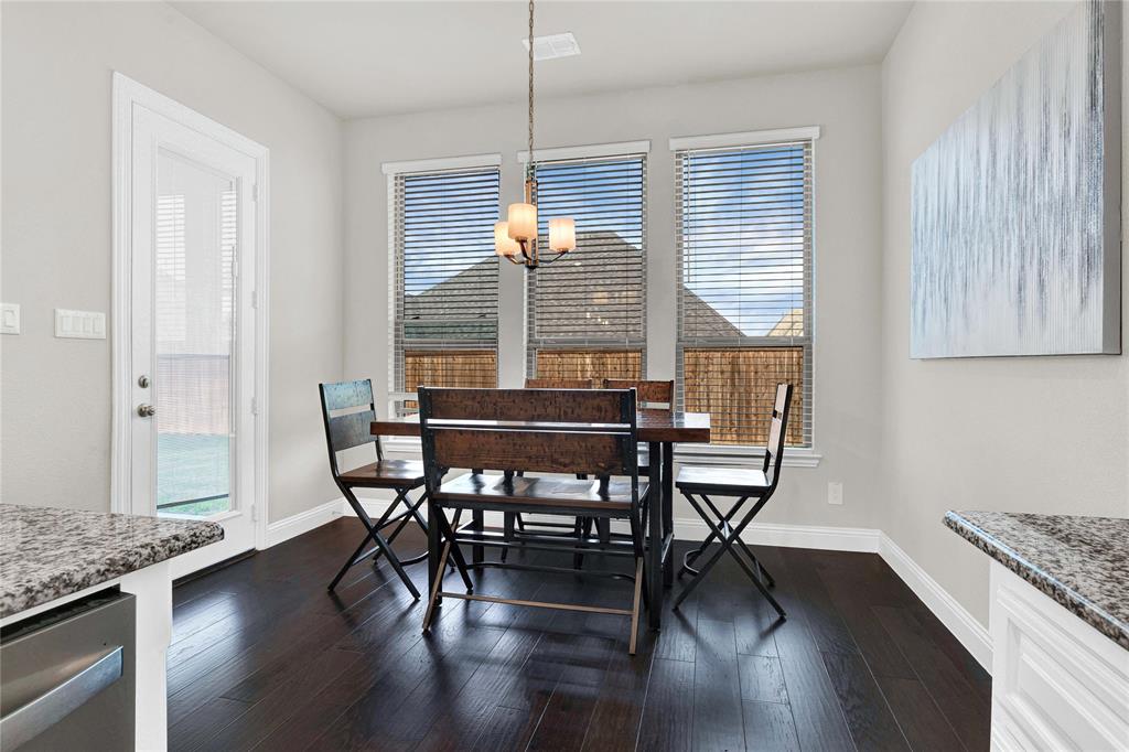 616 Windy Ridge Lane Rockwall, TX 75087 - Photo 8 of 25 a dining room with furniture and wooden floor