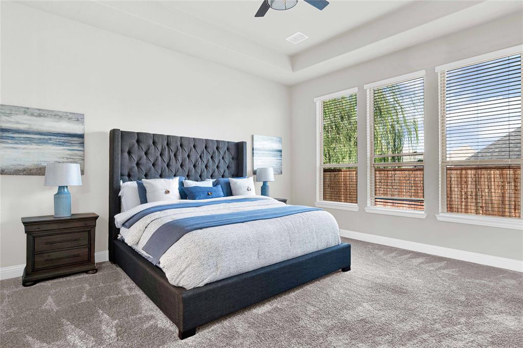 616 Windy Ridge Lane Rockwall, TX 75087 - Photo 9 of 25 a large bed sitting in a bedroom next to a window