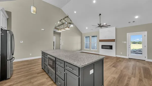 a kitchen with stainless steel appliances granite countertop a refrigerator sink and cabinets