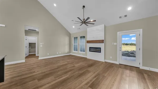 a kitchen with stainless steel appliances granite countertop a refrigerator a sink dishwasher a stove and a refrigerator with wooden floor