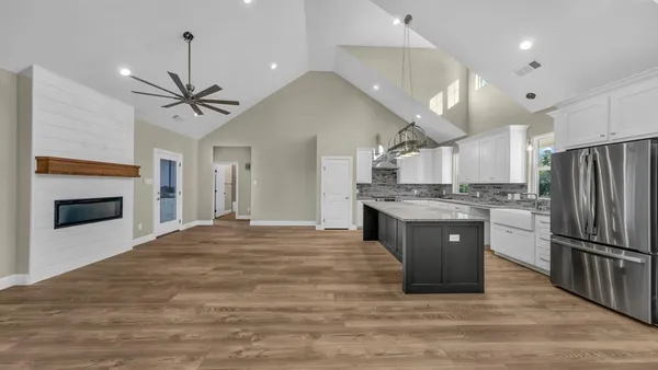 a kitchen with stainless steel appliances granite countertop a sink a refrigerator and a granite counter tops