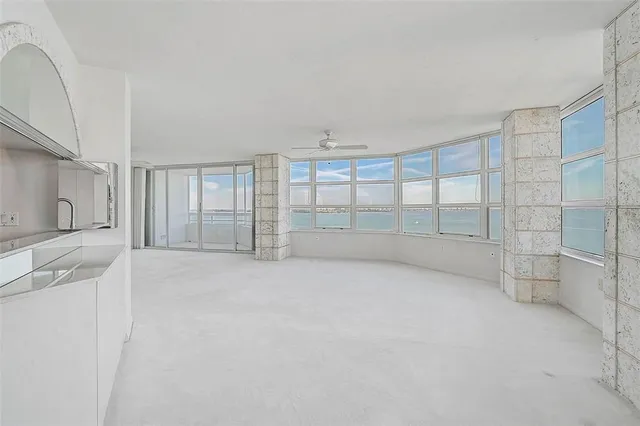 a view of a kitchen with a sink and a refrigerator