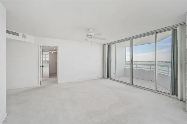 a kitchen with a sink window and cabinets
