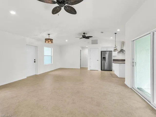 wooden floor in an empty room with a kitchen
