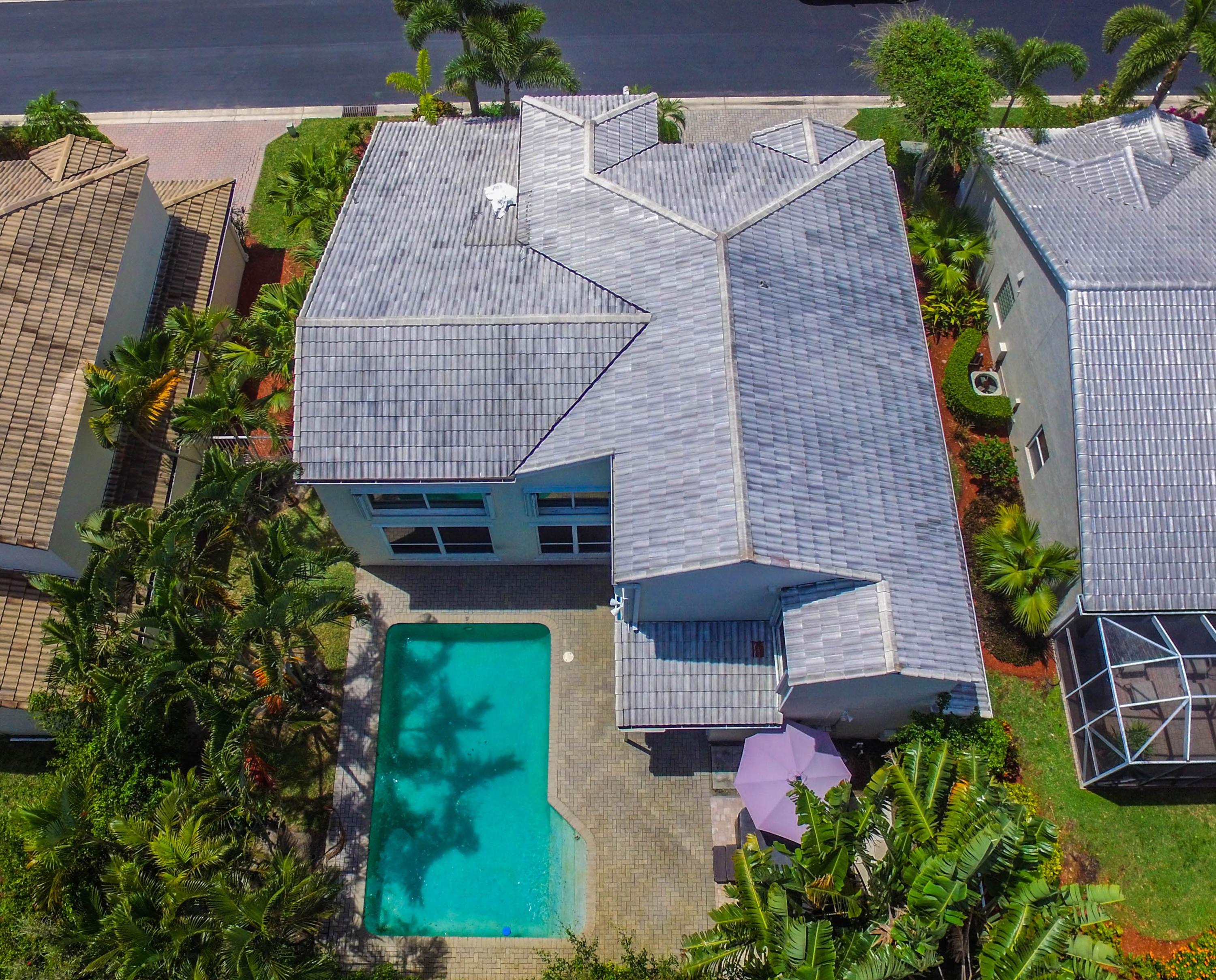 an aerial view of a house with a yard and potted plants