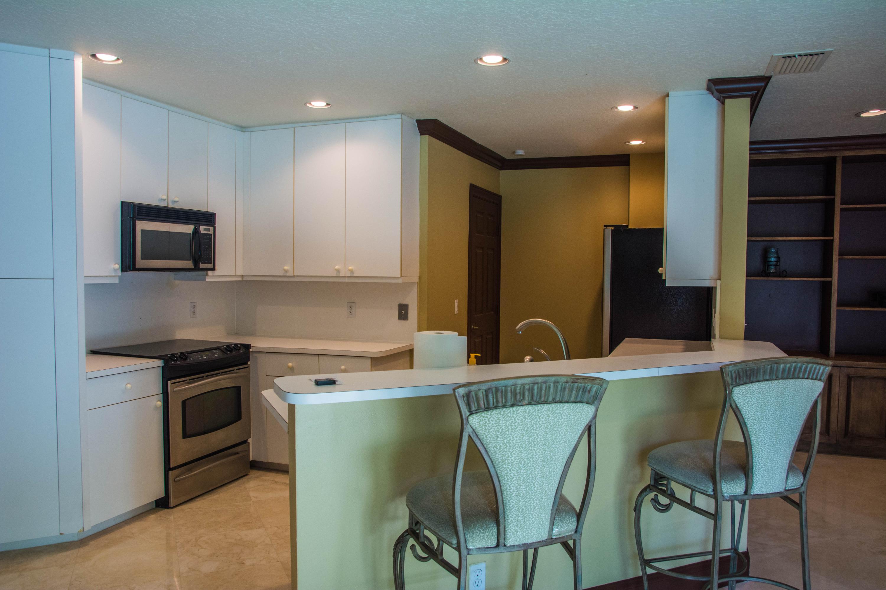17234 Ventana Drive Boca Raton, FL 33487 - Photo 12 of 27 a kitchen with stainless steel appliances kitchen island a refrigerator and a stove top oven