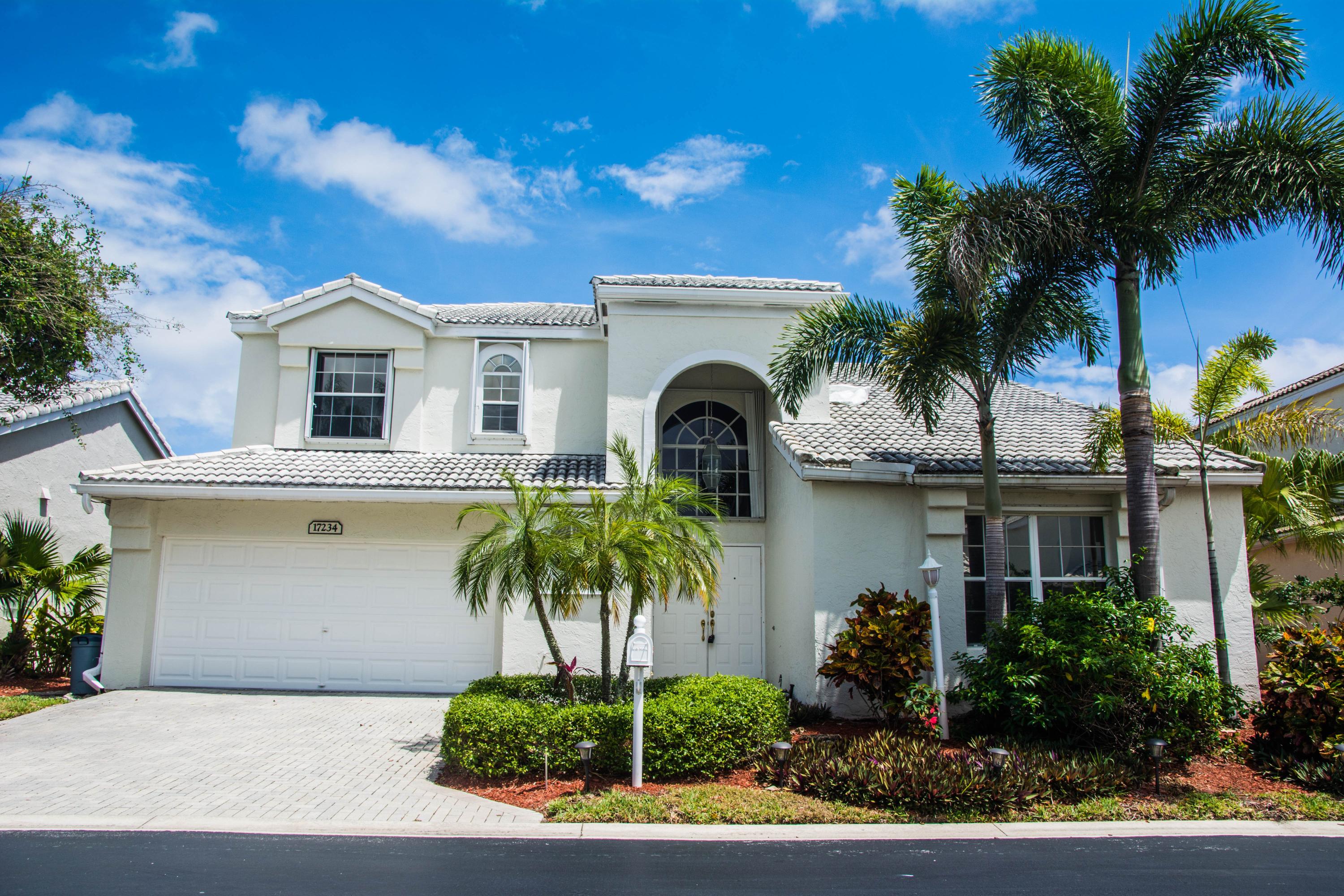 17234 Ventana Drive Boca Raton, FL 33487 - Photo 5 of 27 a front view of a house with a garden