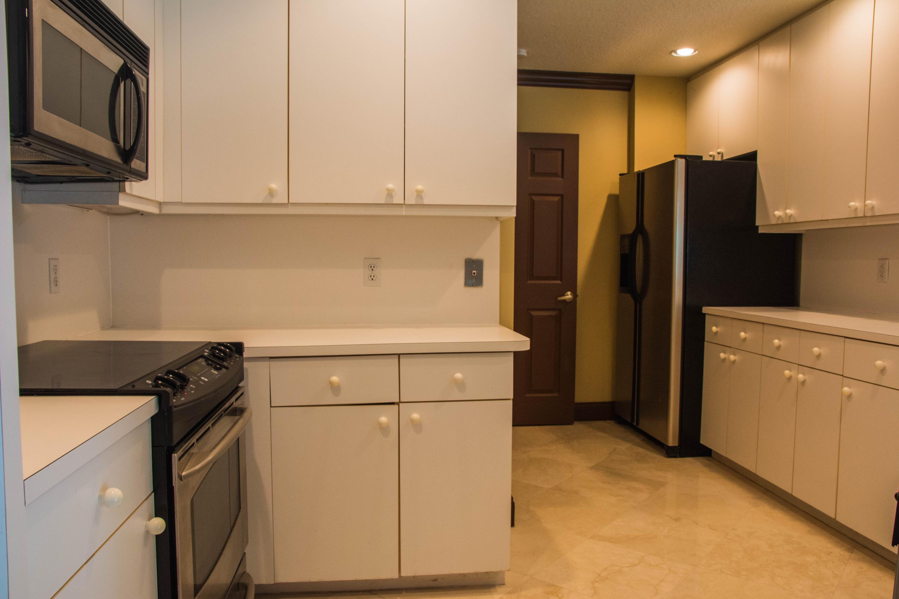 17234 Ventana Drive Boca Raton, FL 33487 - Photo 10 of 27 a kitchen with a refrigerator sink and stove