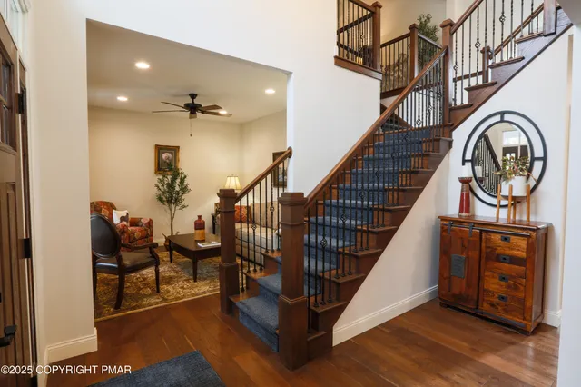 a kitchen with a refrigerator a stove a sink dishwasher a oven with white cabinets and wooden floor