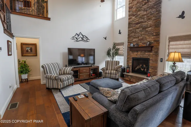 a view of living room with furniture and a fireplace