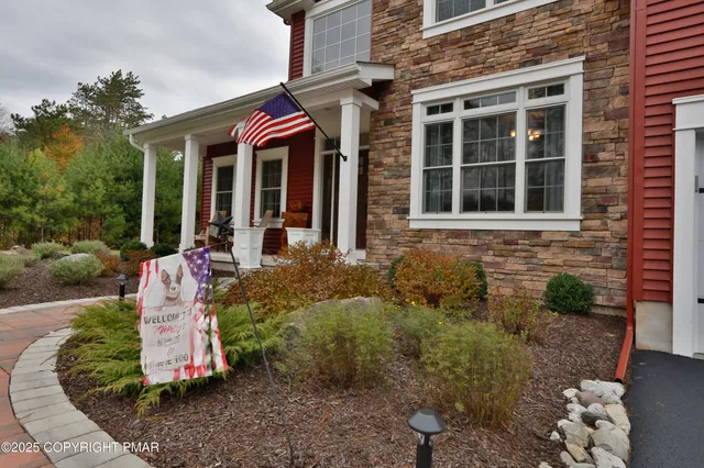 an aerial view of a house with swimming pool next to a big yard