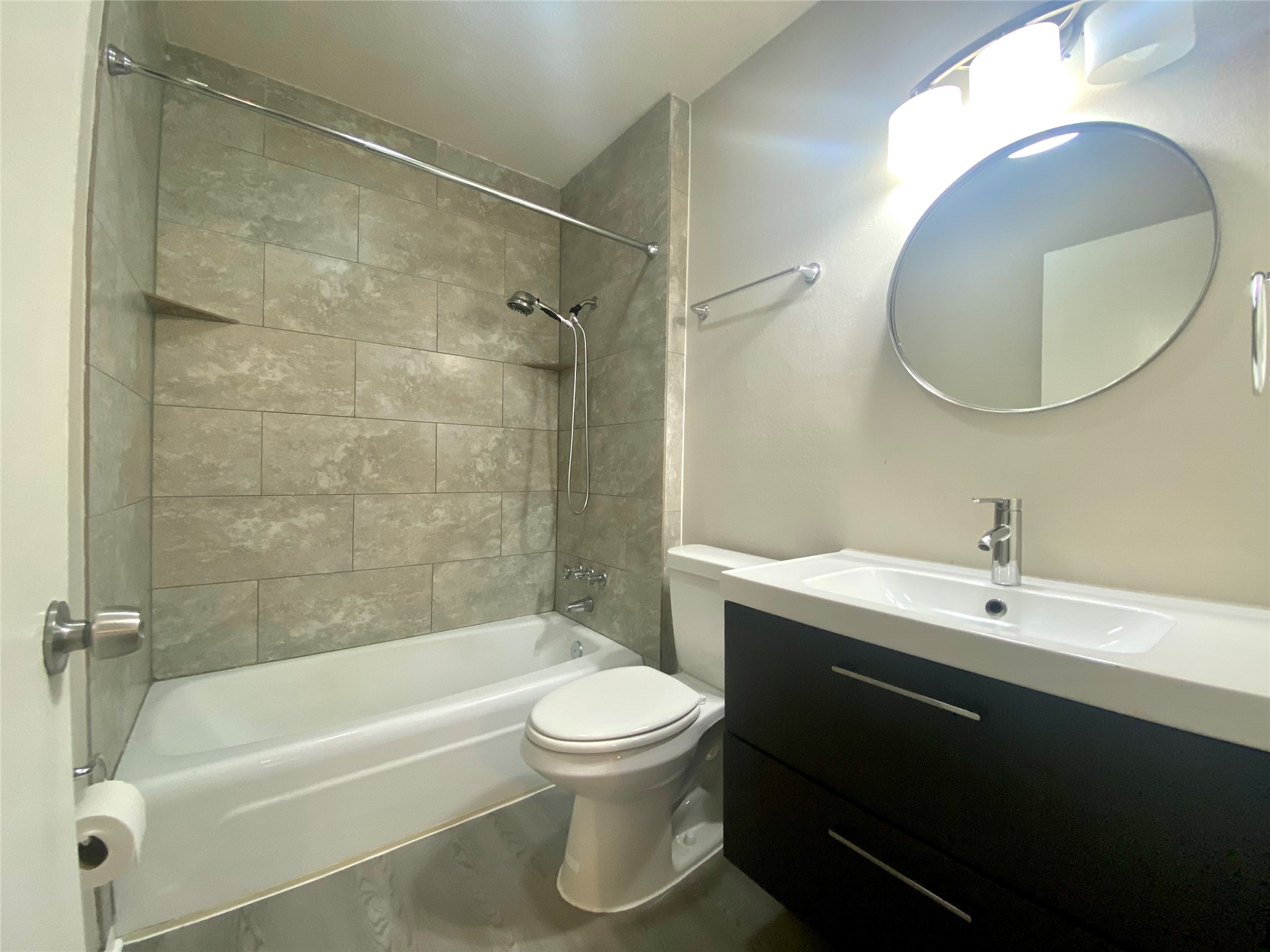 6400 Brookside Drive Austin, TX 78723 - Photo 11 of 26 Bathroom with tub / shower combination, vanity, and wood finished floors