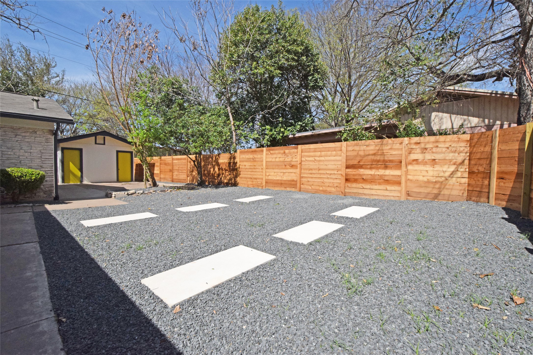 6400 Brookside Drive Austin, TX 78723 - Photo 2 of 26 Fenced backyard with an outbuilding