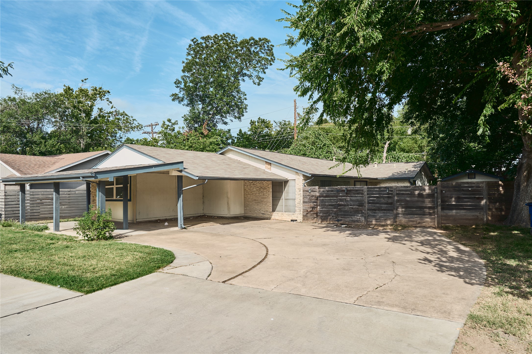 6400 Brookside Drive Austin, TX 78723 - Photo 10 of 26 View of front of home featuring driveway, an attached carport, a shingled roof, and brick siding