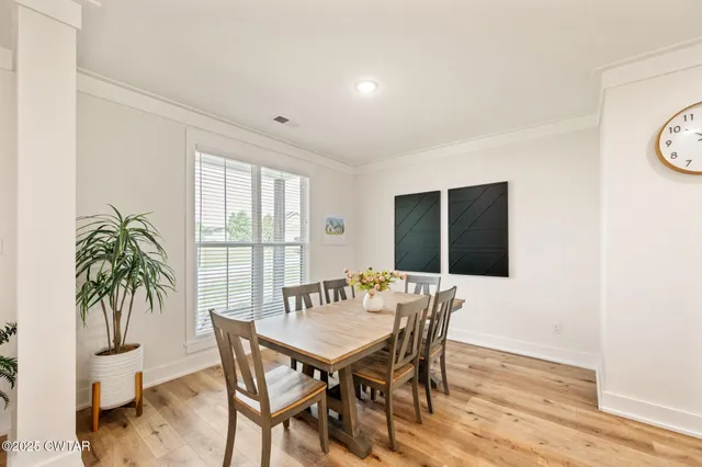 a view of a dining room with furniture and window