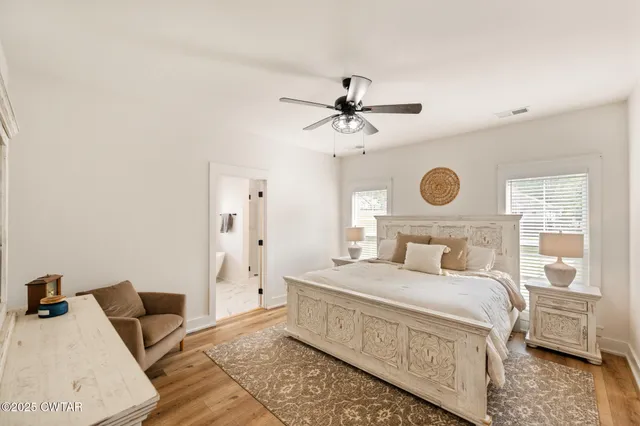 a bedroom with a bed and wooden floor