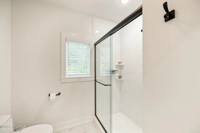 a bathroom with a shower and toilet