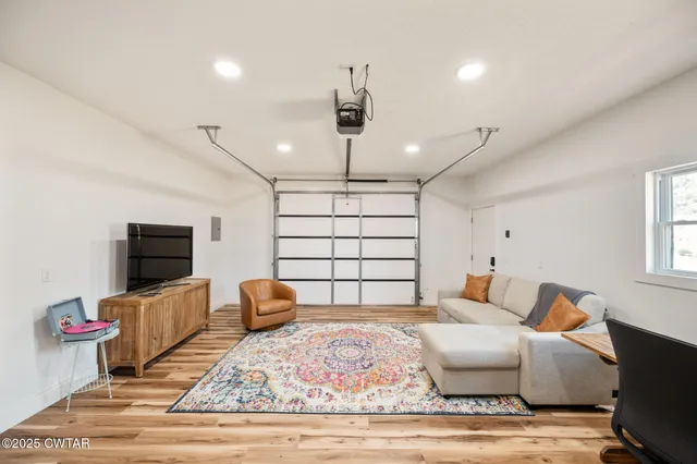 a bedroom with furniture and flat screen tv