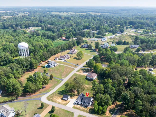 an aerial view of residential houses with outdoor space and street view